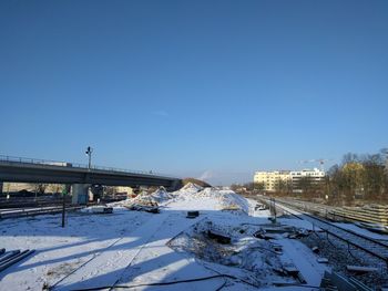 View of railroad tracks against clear sky during winter