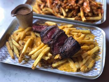 Close-up of steak and fries meal served in plate