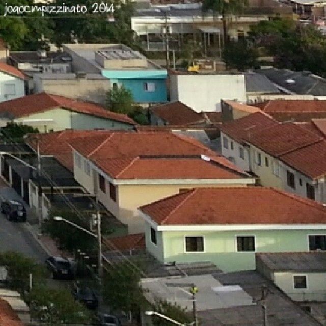 building exterior, architecture, built structure, residential structure, residential building, house, roof, high angle view, residential district, city, town, building, day, outdoors, crowded, window, balcony, townscape, no people, tree