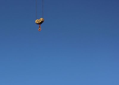 Crane hook against blue sky 