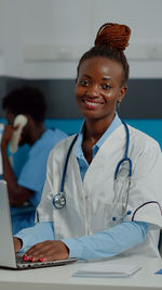 Portrait of smiling doctor in clinic