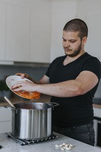 Man in kitchen preparing food