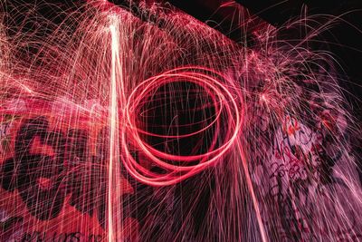 Illuminated firework display at night