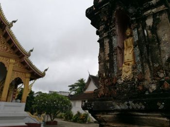 Low angle view of temple against cloudy sky