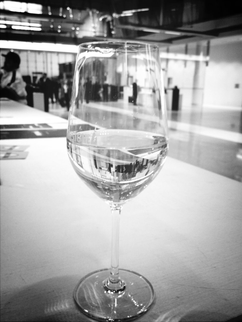 indoors, drinking glass, glass - material, wineglass, drink, food and drink, transparent, refreshment, table, wine, alcohol, restaurant, glass, freshness, focus on foreground, close-up, still life, wine glass, incidental people, alcoholic drink