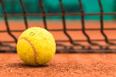 Close-up of yellow ball on tennis court