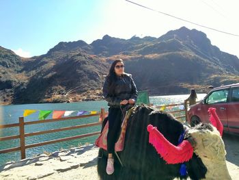 Portrait of woman against mountains against sky