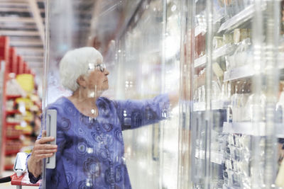 Senior woman doing shopping in supermarket