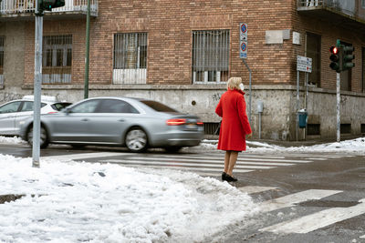 Man standing on street in winter