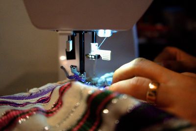 Cropped hands sewing machine