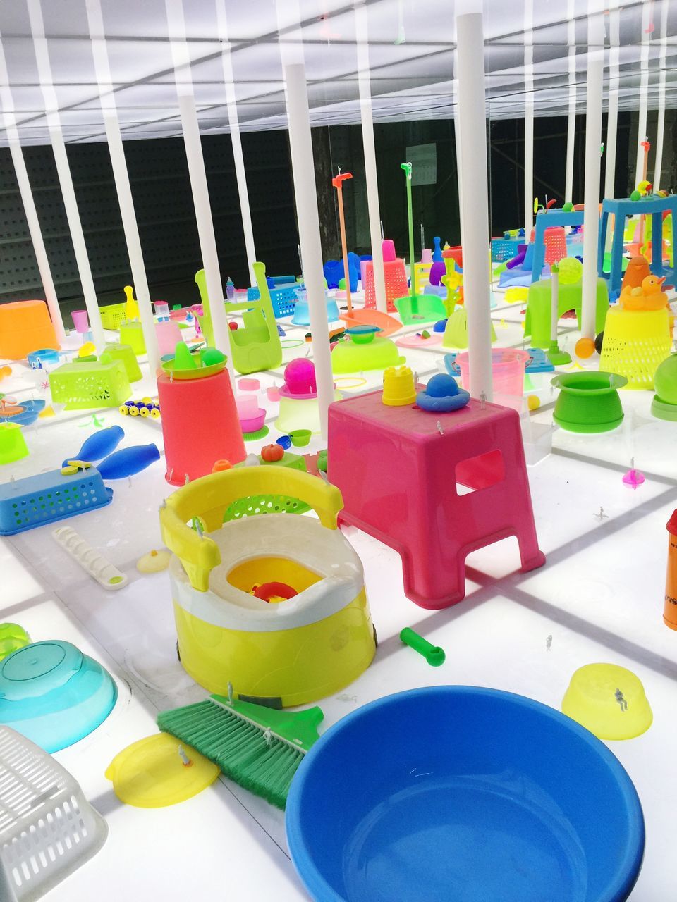 multi colored, indoors, variation, colorful, arrangement, high angle view, choice, table, still life, in a row, large group of objects, no people, childhood, blue, side by side, plastic, yellow, architecture, built structure, day