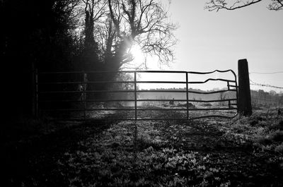 Fence on field against sky