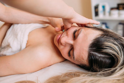 Cosmetologist does facial massage for woman. beauty skin care