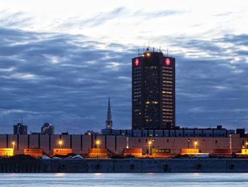 Illuminated building against sky at dusk
