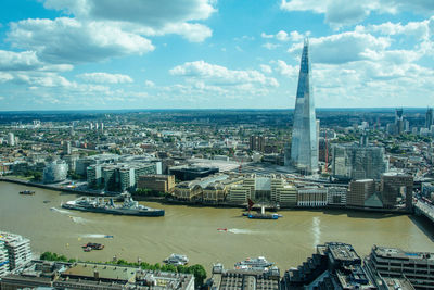 High angle view of buildings against cloudy sky