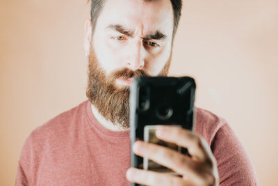 Midsection of man using mobile phone