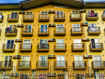 Low angle view of yellow apartment building