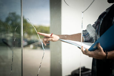 Midsection of man working in glass