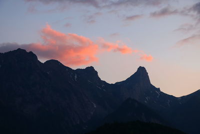 Scenic view of silhouette mountains against sky at sunset