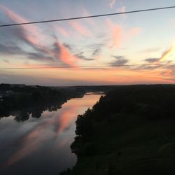 Scenic view of lake against sky at sunset