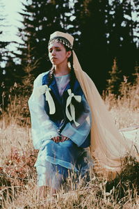Young woman standing in forest