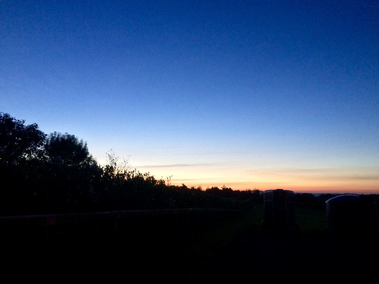 SILHOUETTE LANDSCAPE AGAINST CLEAR BLUE SKY