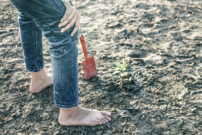 Low section of woman standing on ground