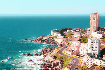 High angle view of sea and buildings against sky