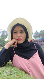 Portrait of beautiful young woman in hat