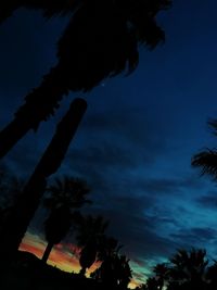 Low angle view of silhouette palm trees against sky at sunset