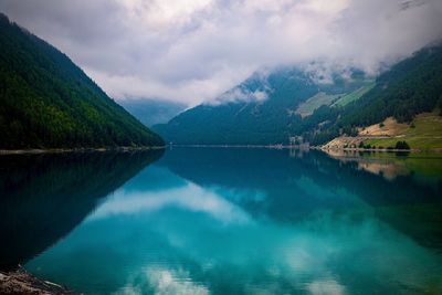 Scenic view of lake and mountains against sky