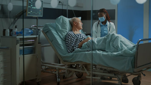 Doctor wearing mask examining patient