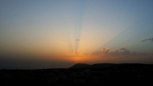 Silhouette landscape against clear sky during sunset