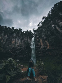 Girl surfing on rocks