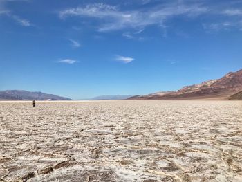 Scenic view of desert against blue sky