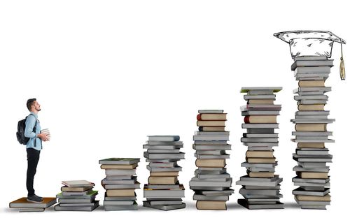 Stack of books on table against white background