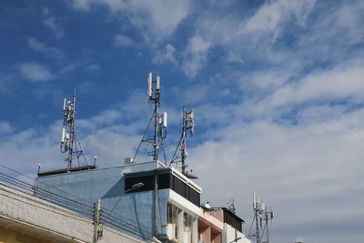 Low angle view of buildings against cloudy sky