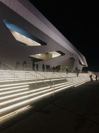Low angle view of illuminated buildings in city at night