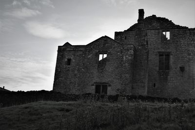 Low angle view of old building against sky