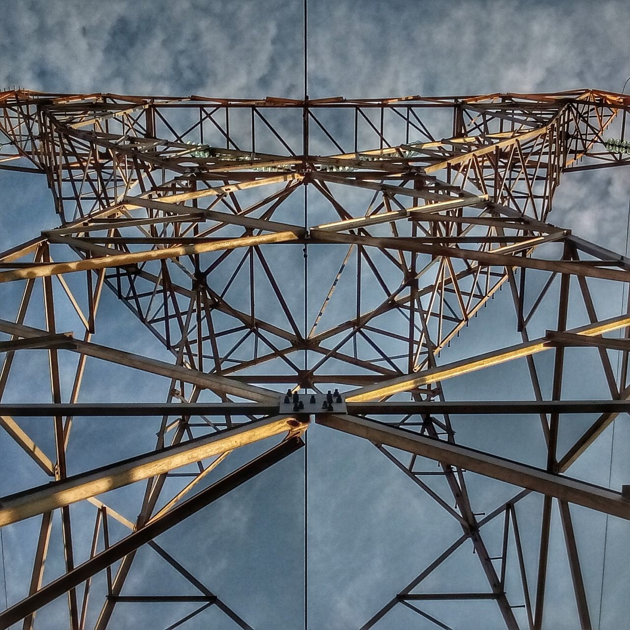 low angle view, metal, sky, built structure, metallic, engineering, connection, amusement park ride, blue, architecture, amusement park, day, iron - metal, outdoors, cloud - sky, famous place, cloud, geometric shape, national landmark, no people