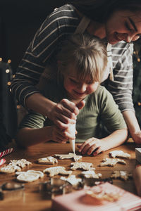 Christmas and new year food preparation. gingerbread cooking, decorating cookies with icing, mastic