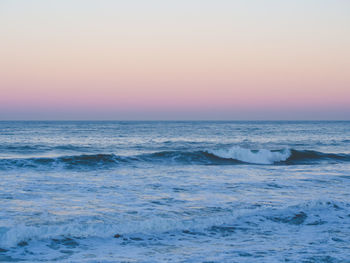 Scenic view of sea against clear sky during sunset