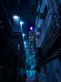 Low angle view of illuminated buildings in city at night