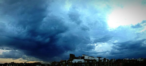 Low angle view of buildings against cloudy sky