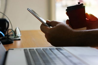 Midsection of person using mobile phone