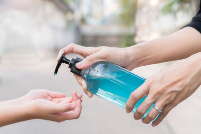 Close-up of woman hand holding bottle