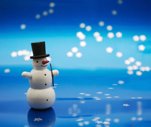 Close-up of snowman figurine on table