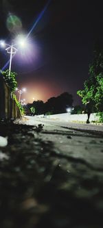 Surface level of street against illuminated city at night