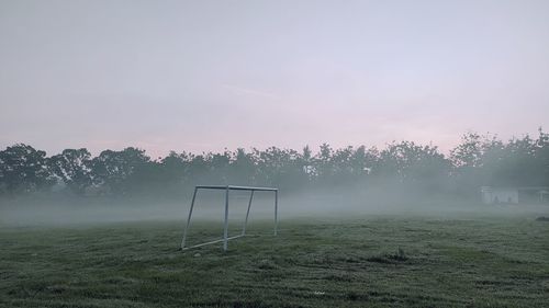 Scenic view of field against sky during foggy weather