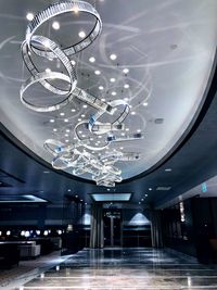 Low angle view of illuminated chandelier in shopping mall